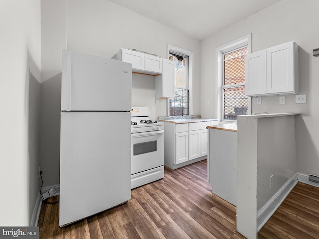 kitchen featuring white cabinetry, dark hardwood / wood-style floors, and white appliances