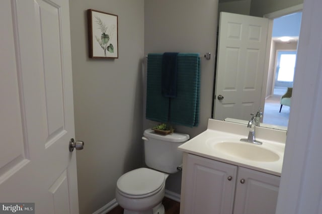 bathroom featuring toilet and vanity