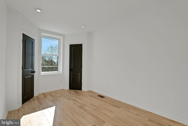 spare room with light hardwood / wood-style flooring