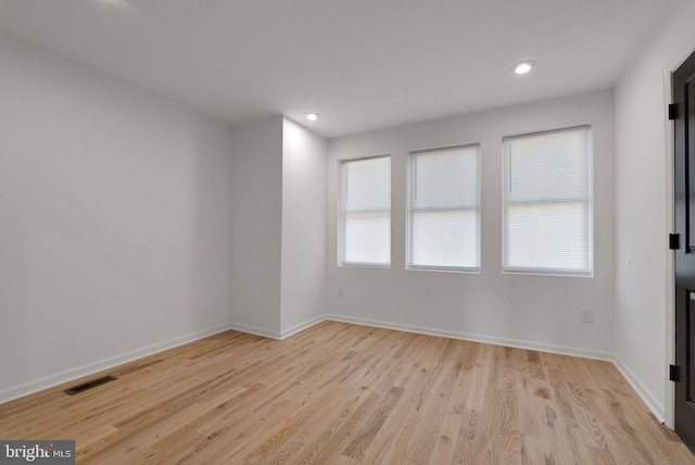 empty room with light hardwood / wood-style flooring