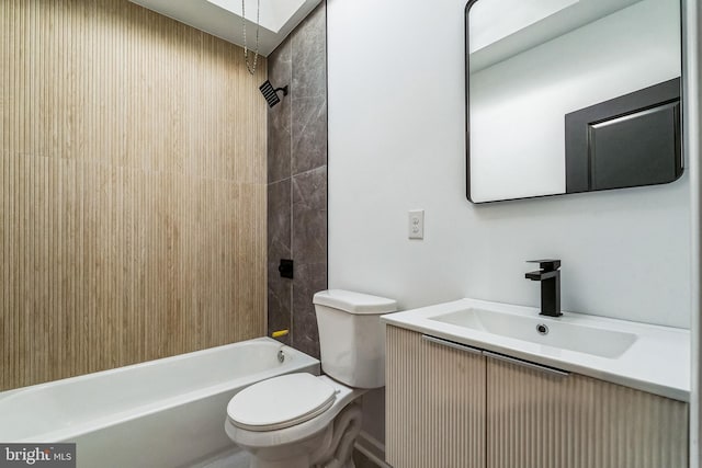 full bathroom with vanity, tiled shower / bath combo, and toilet