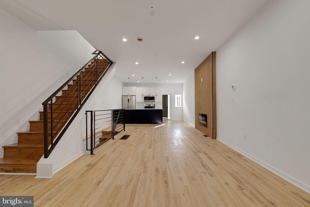 unfurnished living room featuring light hardwood / wood-style floors