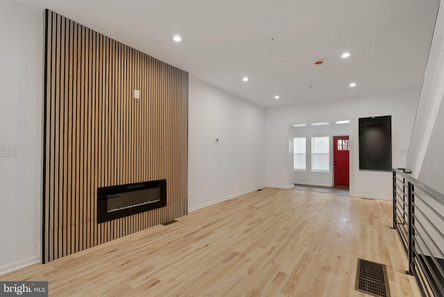 unfurnished living room with light wood-type flooring