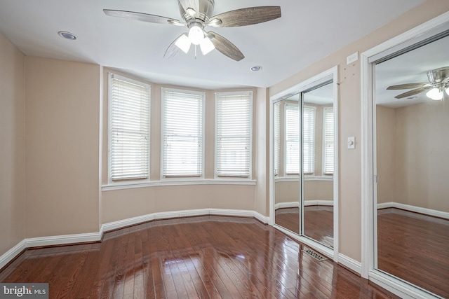 unfurnished room with ceiling fan and hardwood / wood-style flooring