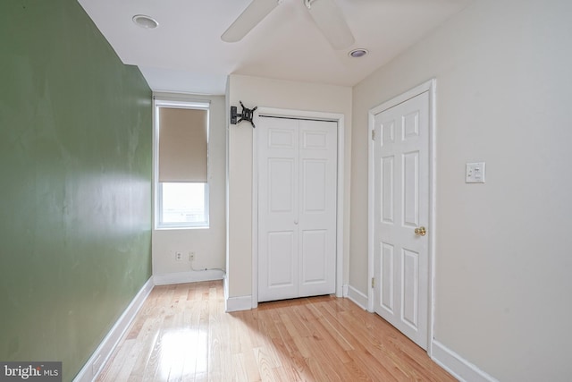 unfurnished bedroom with a closet, ceiling fan, and light hardwood / wood-style floors