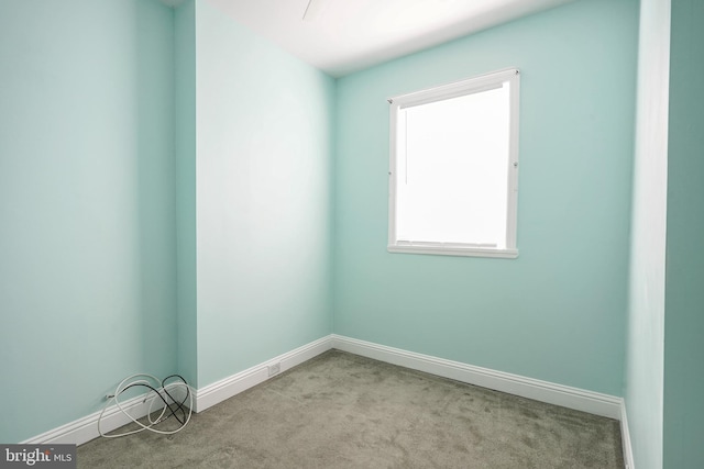 unfurnished room featuring light carpet