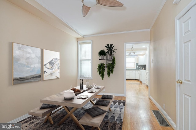 dining room with ceiling fan, ornamental molding, and hardwood / wood-style floors