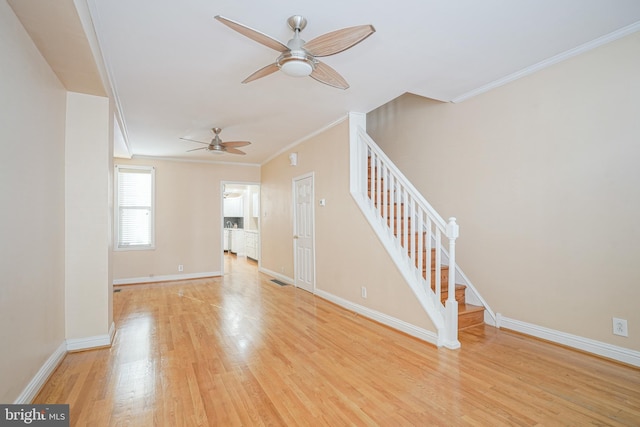 unfurnished living room featuring light hardwood / wood-style floors, ceiling fan, and crown molding