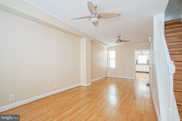 unfurnished living room featuring light hardwood / wood-style floors and crown molding