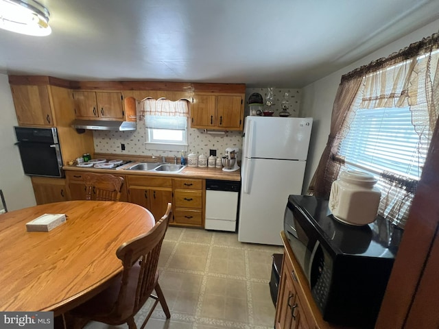 kitchen with sink and white appliances