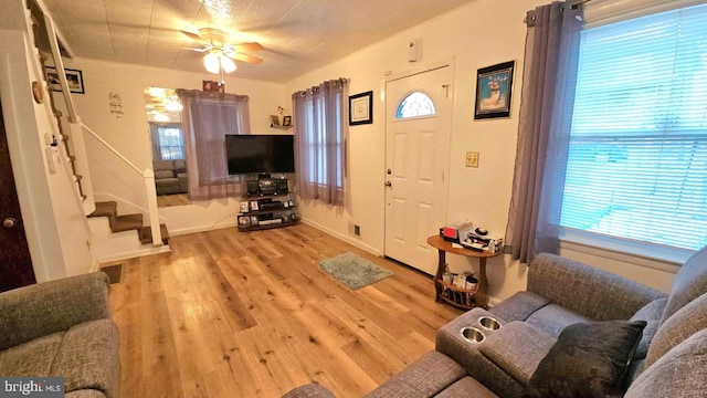 living room with ceiling fan and light hardwood / wood-style floors