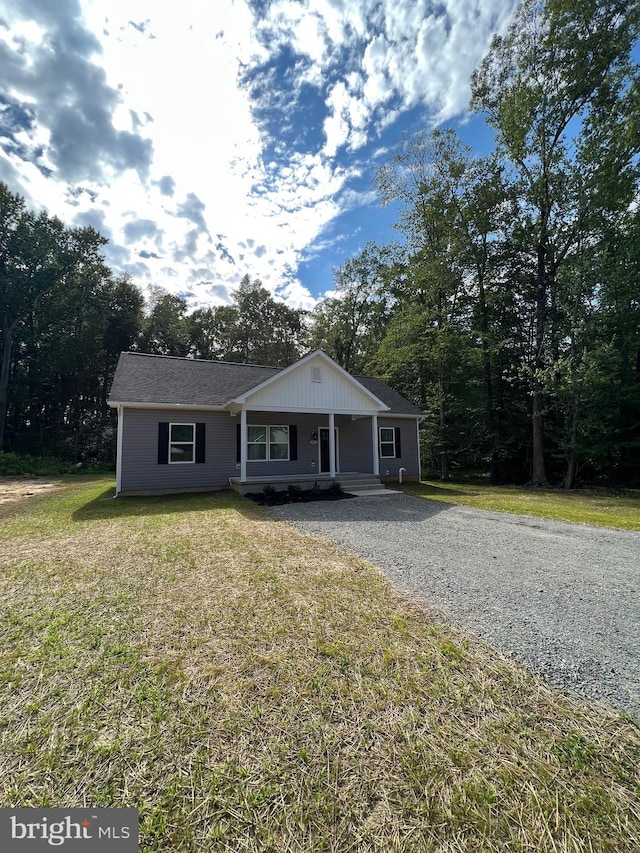 view of front of home with a porch and a front lawn