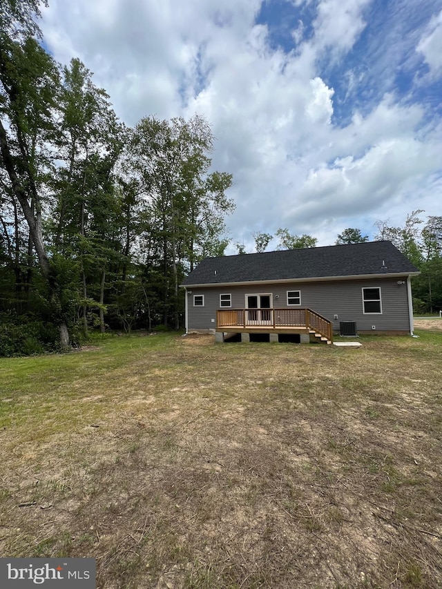 rear view of property with a lawn and a deck