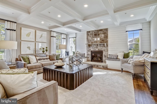 living room featuring dark wood-type flooring, coffered ceiling, beamed ceiling, wooden walls, and a fireplace