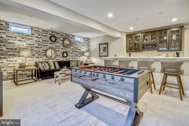 playroom featuring bar area and light carpet