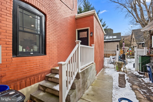 view of snow covered property entrance