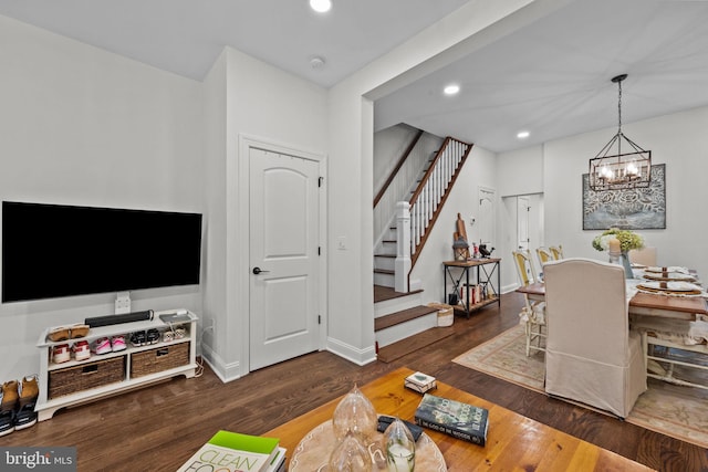 interior space featuring dark hardwood / wood-style flooring and an inviting chandelier