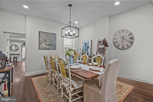 dining room with dark hardwood / wood-style floors and a notable chandelier