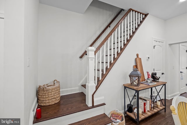 stairs featuring wood-type flooring