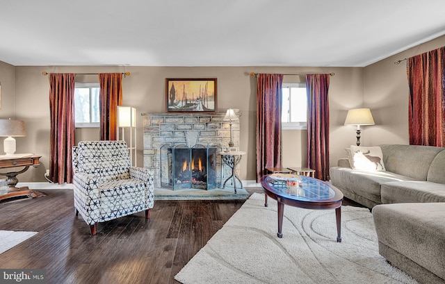 living room with wood-type flooring and a fireplace