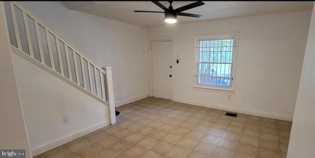 foyer entrance featuring ceiling fan