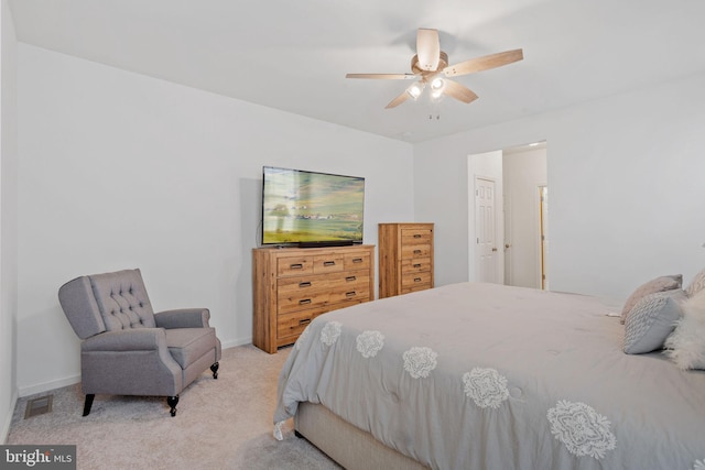 carpeted bedroom featuring ceiling fan and a closet