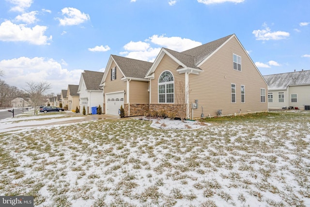 view of snow covered exterior with a garage