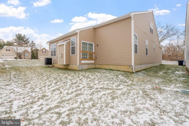 snow covered property featuring central AC unit