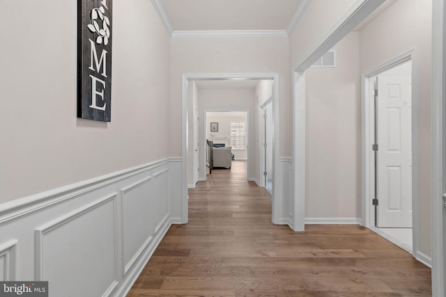 hall with crown molding and hardwood / wood-style floors