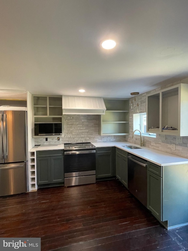 kitchen with custom exhaust hood, appliances with stainless steel finishes, sink, and dark wood-type flooring