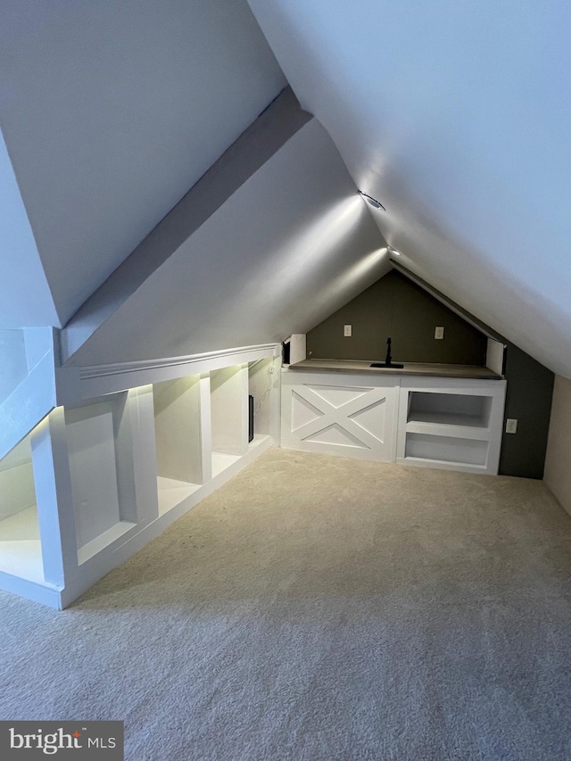 bonus room featuring vaulted ceiling and carpet