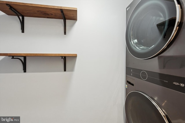 laundry room featuring stacked washer / drying machine