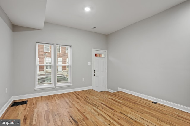 unfurnished room with wood-type flooring