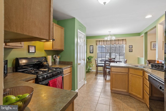 kitchen with sink, hanging light fixtures, a chandelier, light tile patterned flooring, and black appliances