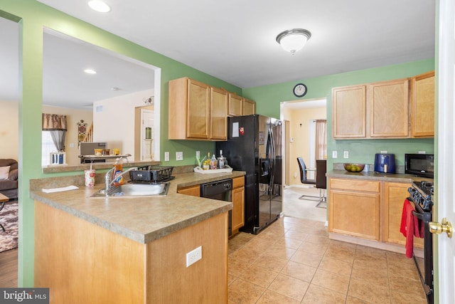 kitchen featuring sink, kitchen peninsula, light brown cabinetry, light tile patterned flooring, and black appliances