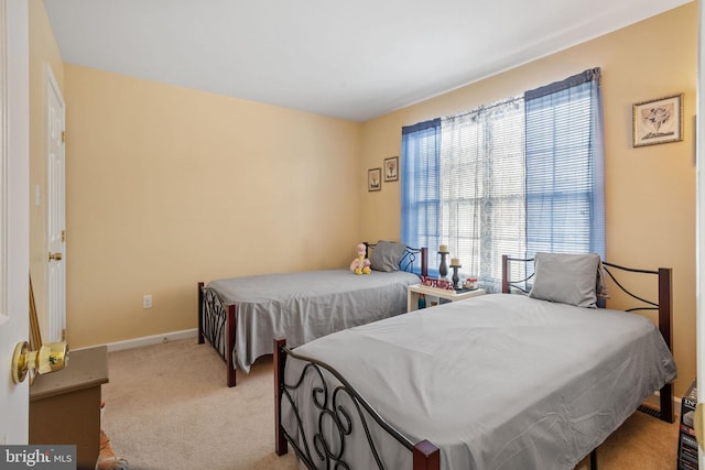 bedroom featuring light carpet