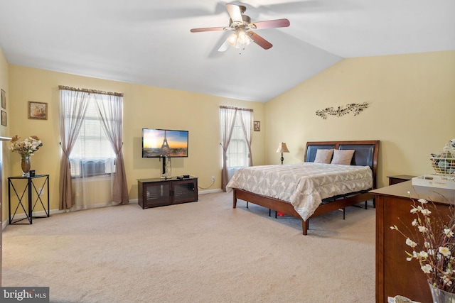 bedroom with ceiling fan, light colored carpet, and vaulted ceiling