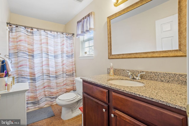 bathroom with tile patterned floors, vanity, and toilet