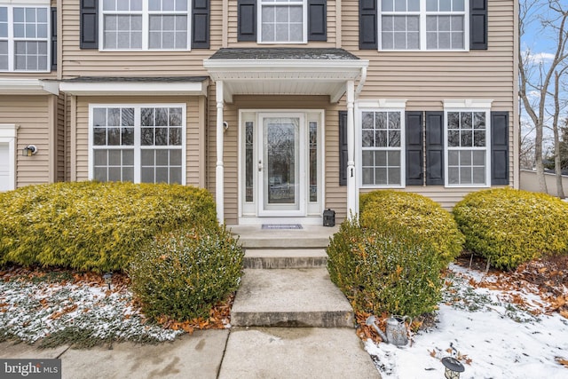 view of snow covered property entrance