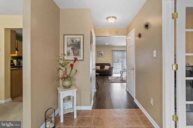 hall with dark tile patterned floors