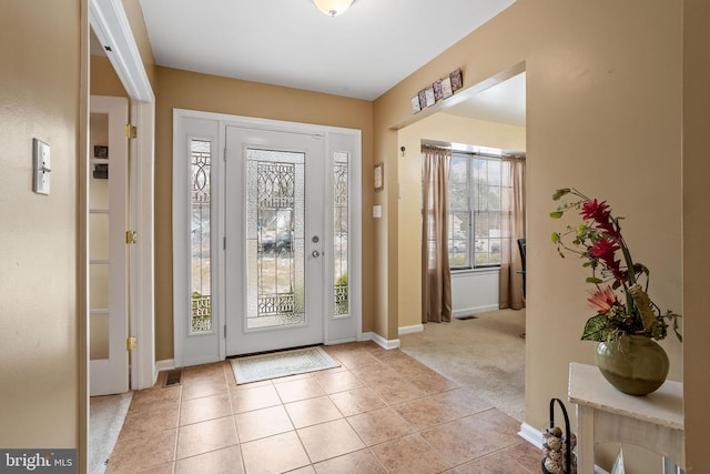 foyer entrance with light colored carpet