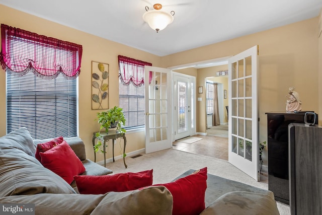 carpeted living room featuring french doors