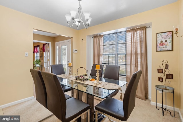 carpeted dining space with a wealth of natural light and a notable chandelier