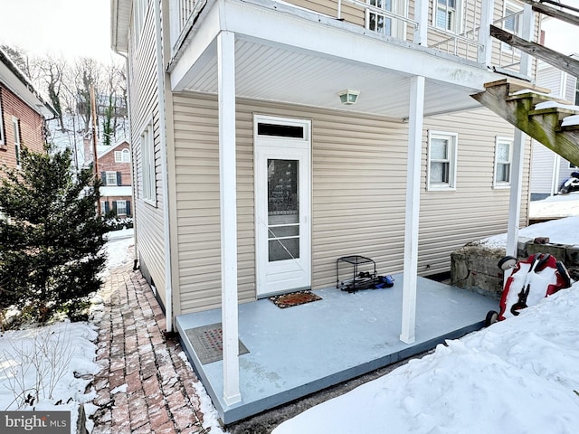 view of snow covered property entrance