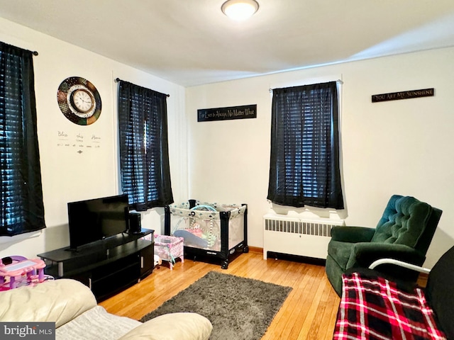 living room featuring hardwood / wood-style floors and radiator heating unit