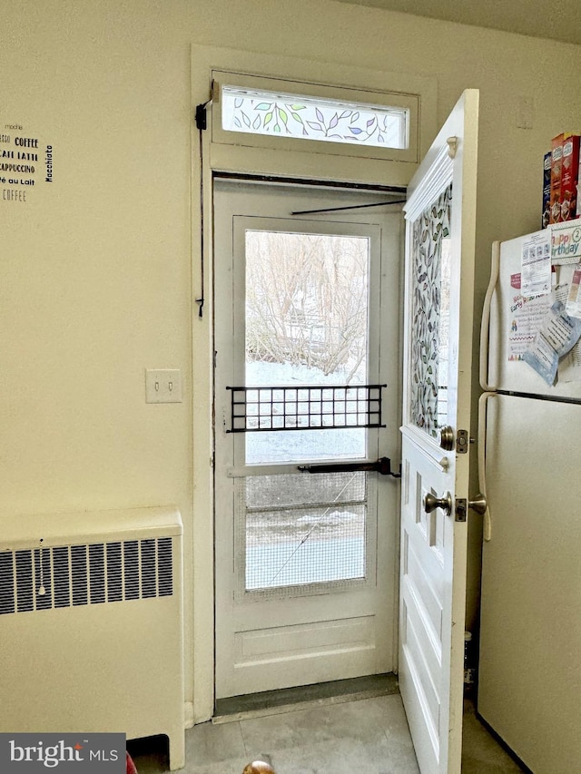 doorway to outside featuring radiator heating unit