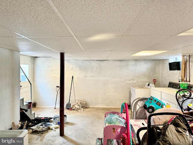 basement featuring washer and clothes dryer and a paneled ceiling