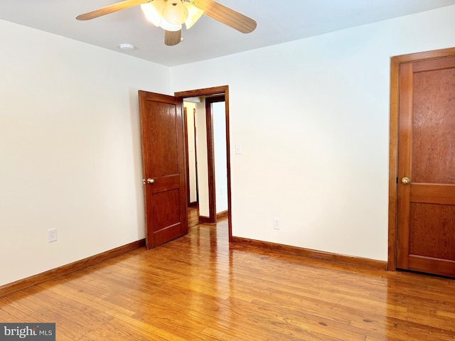 empty room featuring ceiling fan and light hardwood / wood-style flooring