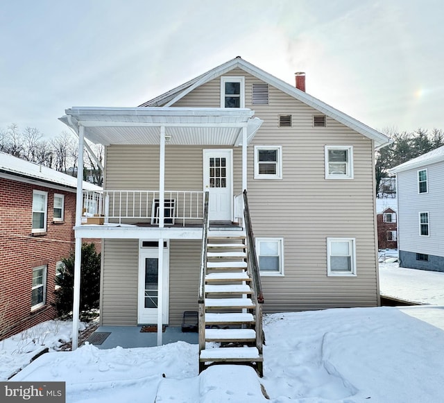 snow covered house with a balcony