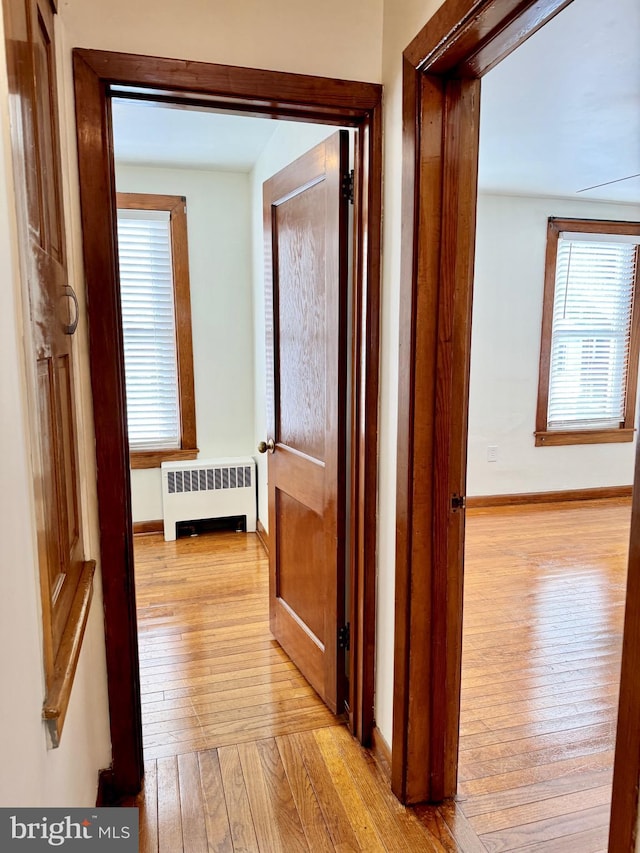 hall featuring radiator and light hardwood / wood-style floors